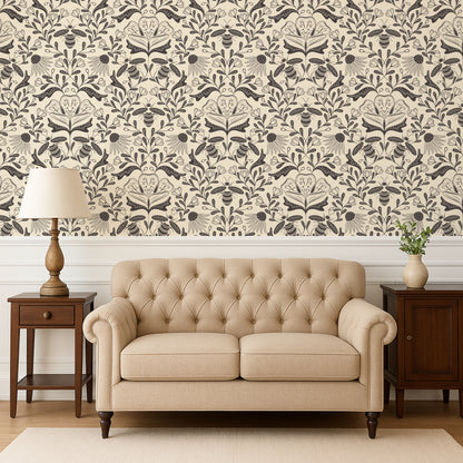 Beige tufted sofa in a room with decorative wallpaper and side tables.
