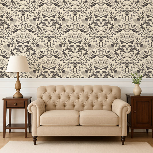 Beige tufted sofa in a room with decorative wallpaper and side tables.