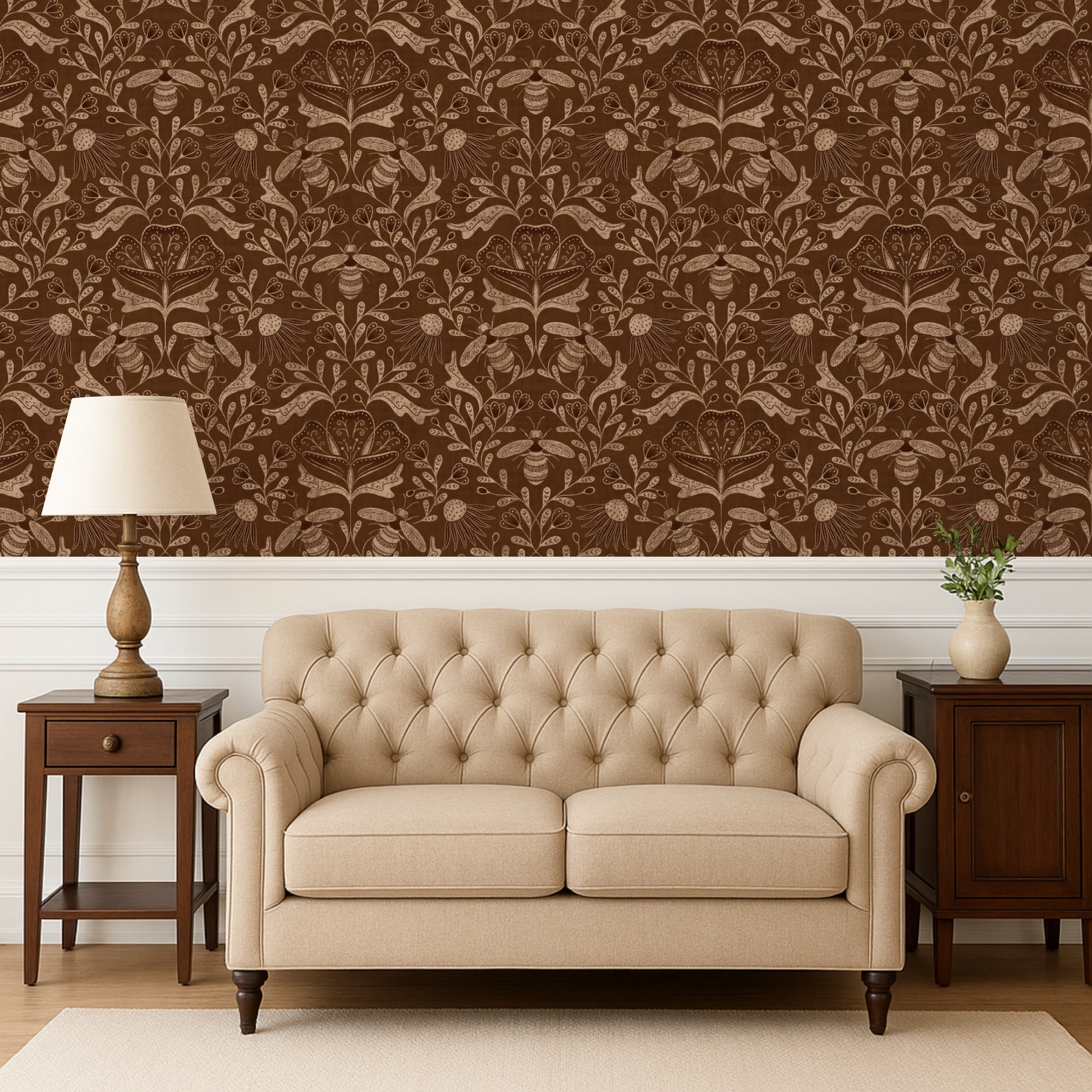 Beige tufted sofa in a room with brown patterned wallpaper and wooden furniture.