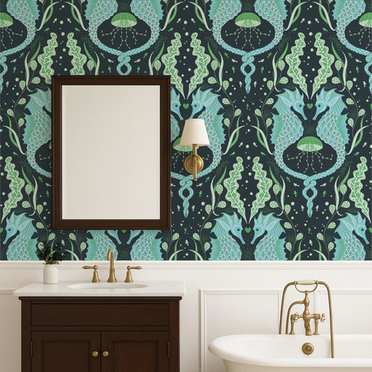Bathroom with decorative wallpaper featuring green and blue patterns, a mirror, and sink.