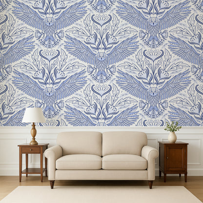 Living room with a beige sofa, wooden side tables, and a wall featuring a blue and white owl pattern.
