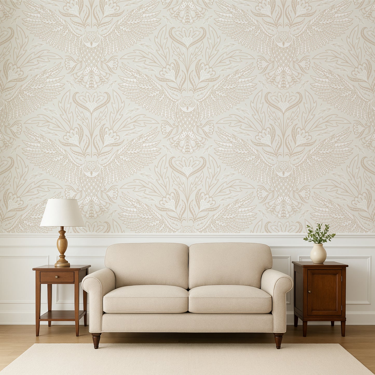 Beige sofa in a room with decorative wallpaper and wooden side tables.