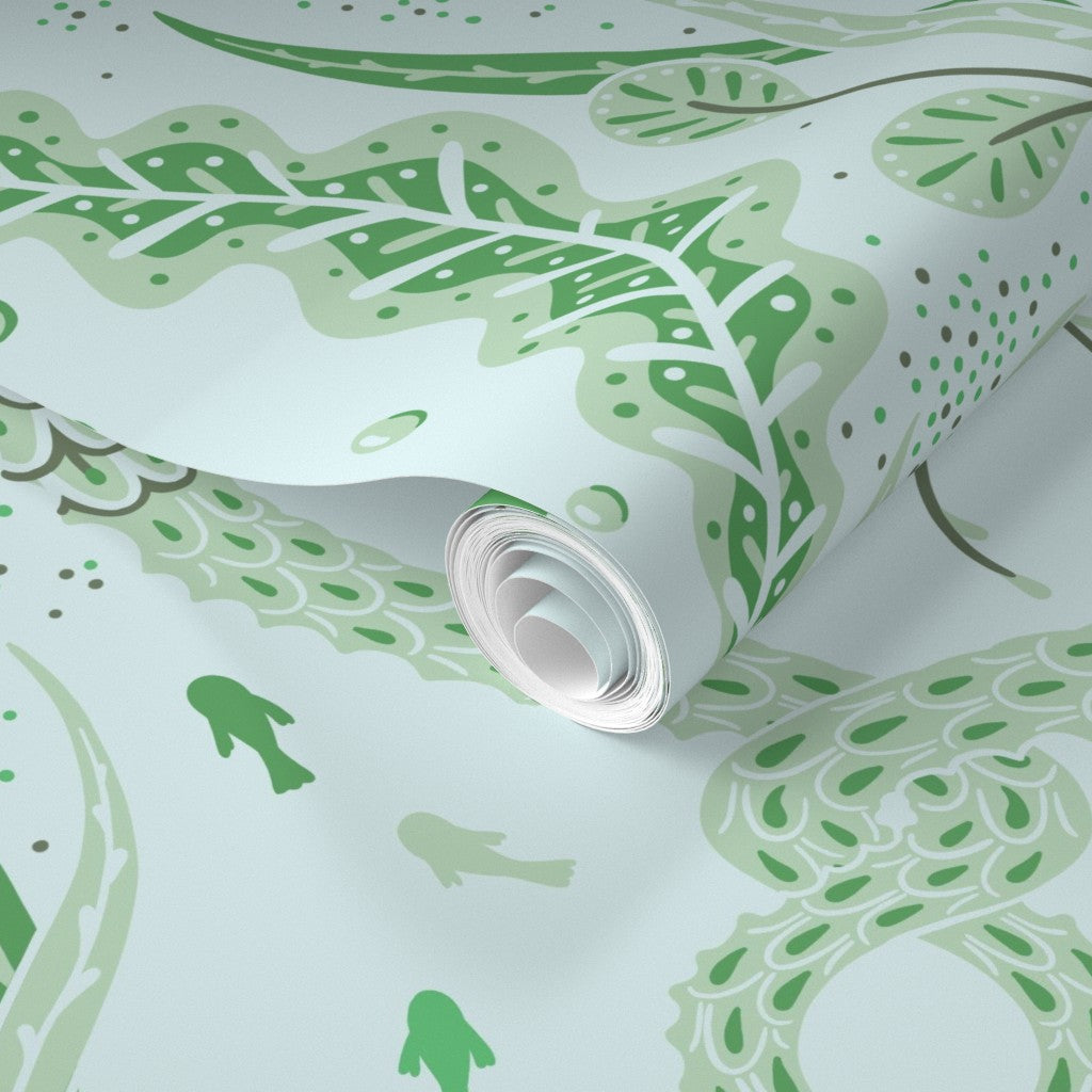 Roll of green patterned wallpaper on a light background