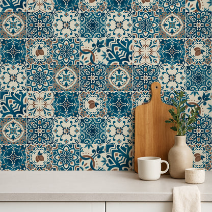 Decorative mosaic tiles with a wooden cutting board, white mug, and plant on a countertop.